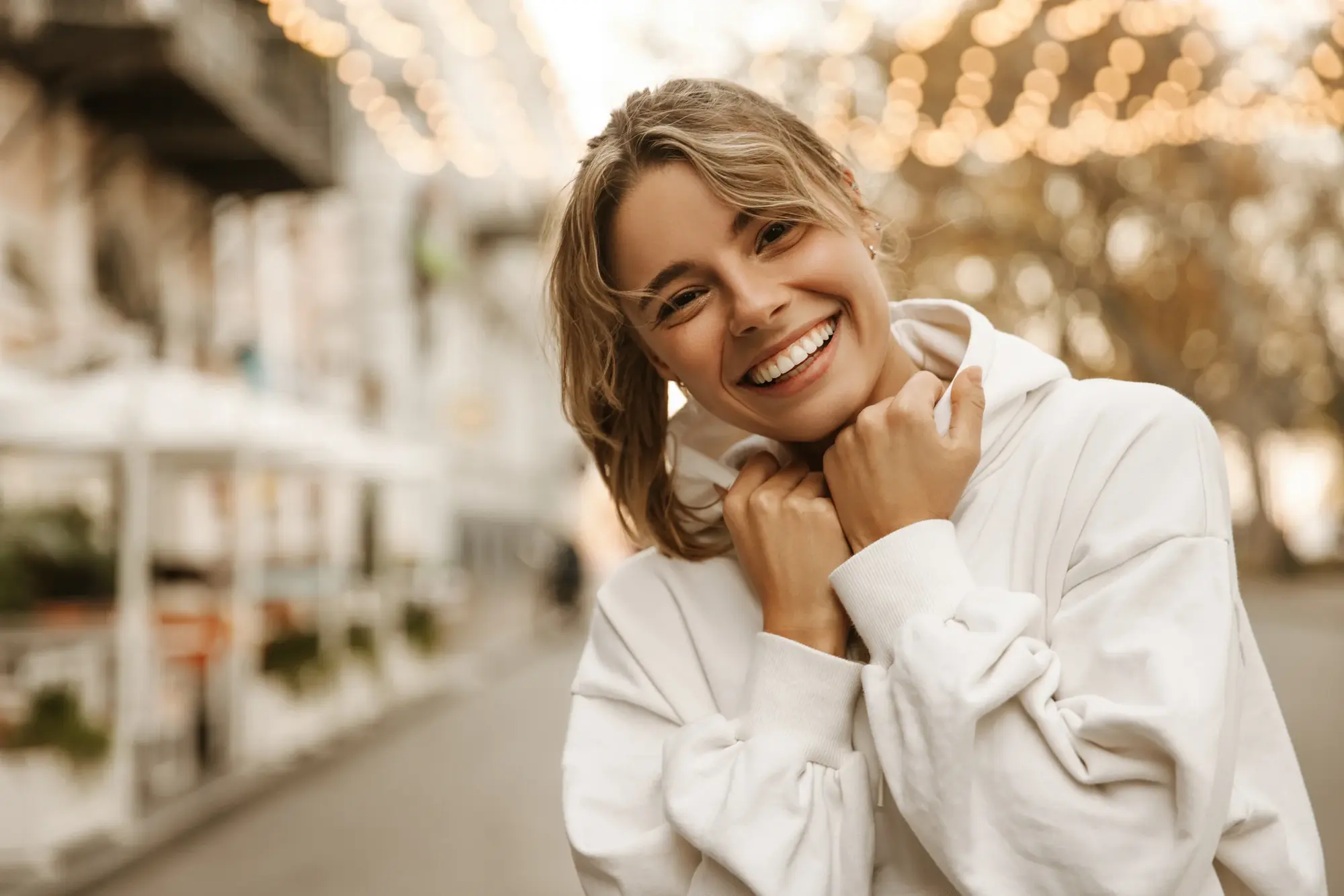 Patient with a restored smile after crown treatment